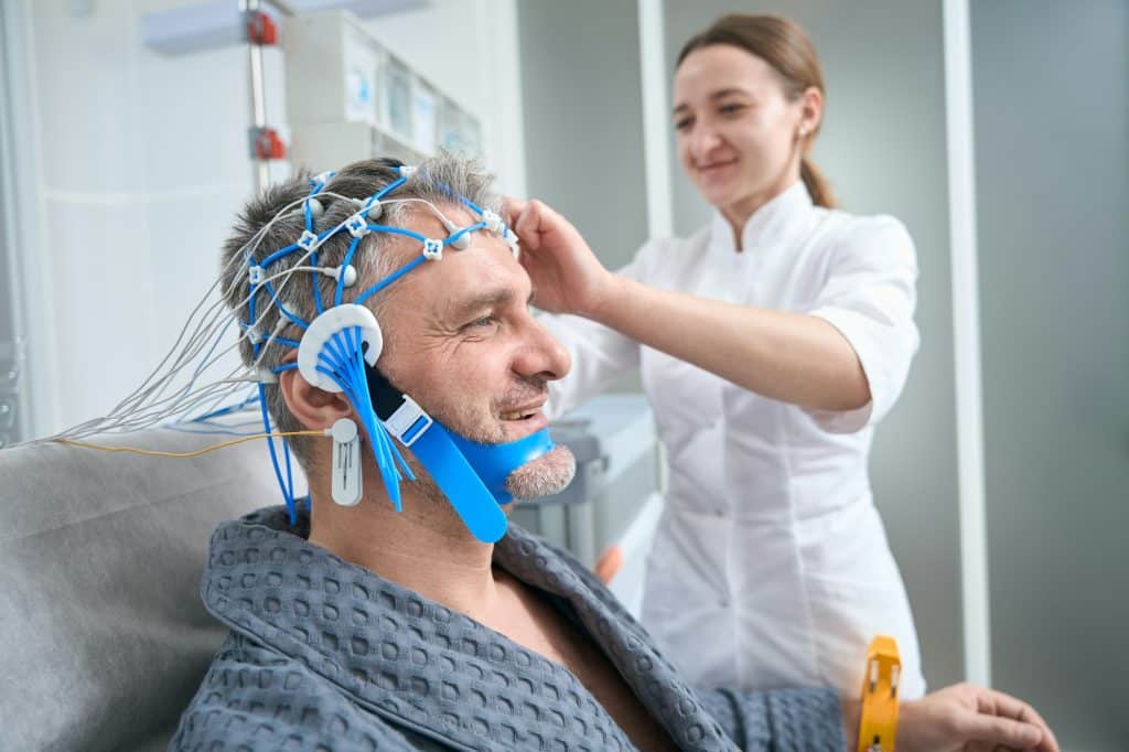 Doctor attaches the sensors to the patient head