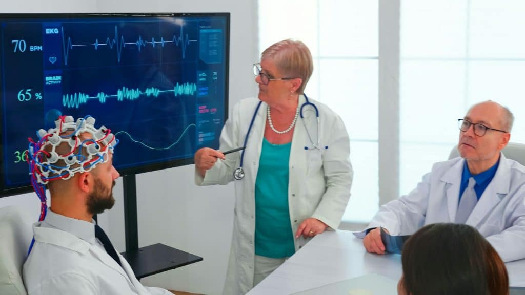 Scientist doing brain analysis using headset with sensors on doctor